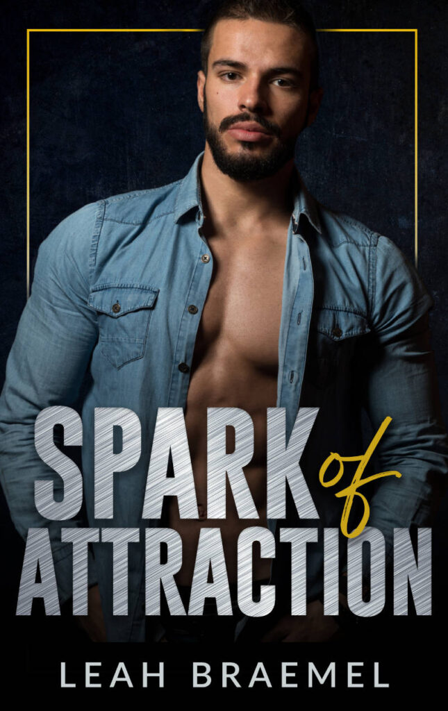 Cover image, title text in brushed metal says Spark of Attraction, in white text author name Leah Braemel, all in front of a handsome man in a blue denim shirt that is open exposing his chest. He has dark hair and beard
